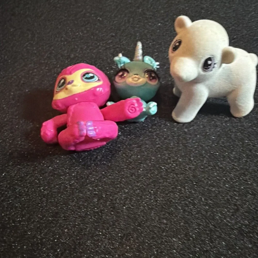 three small collectible toy figurines: Baby Crystals, Bounce Scribble Scrubbie k